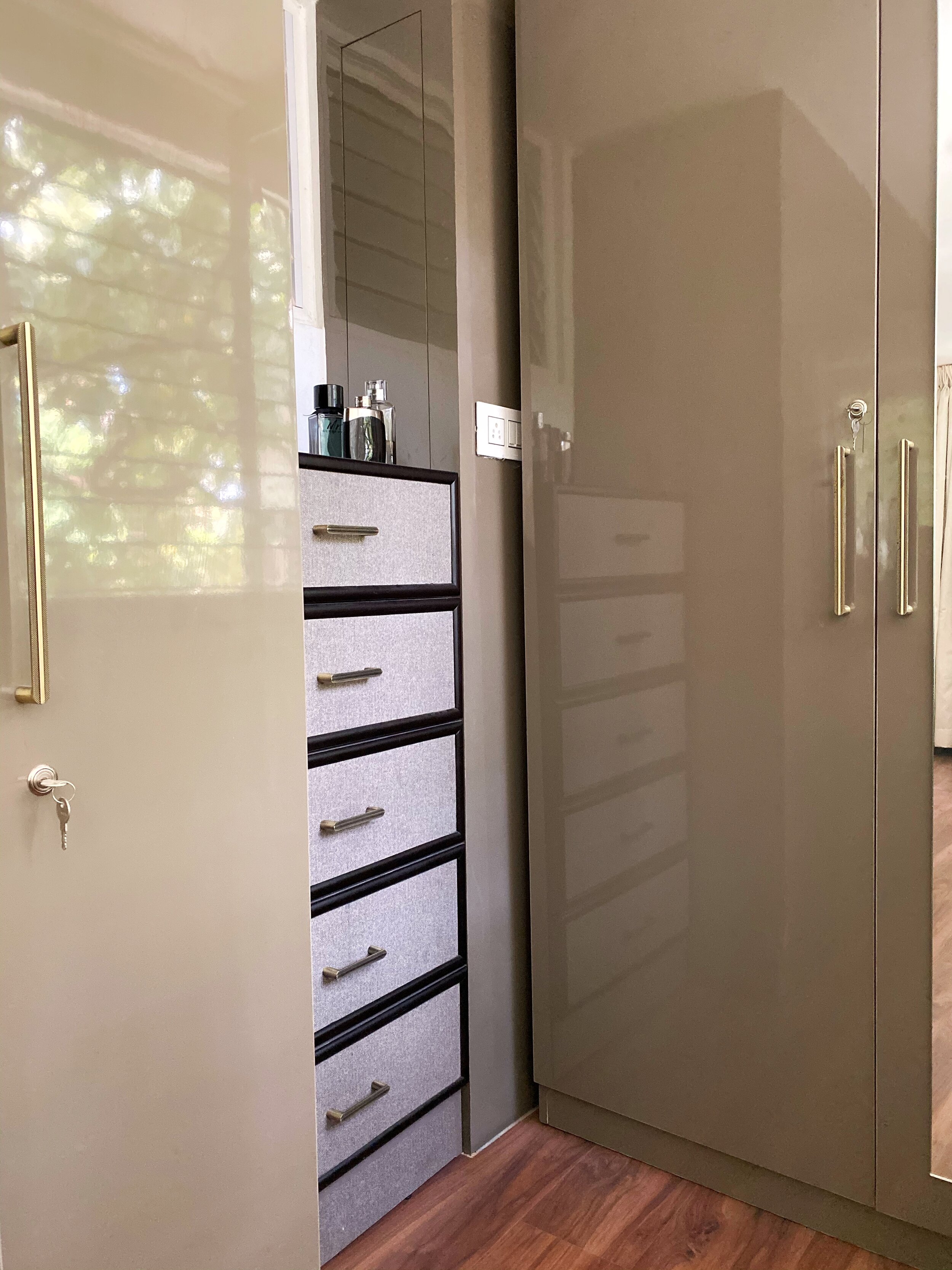 Since this was initially supposed to be a balcony the bathroom window opens out into this space so we couldn't fit in a full length wardrobe here so we decided to add a chest of drawer in a contrast tweed laminate framed in black for him as a small dress up corner.